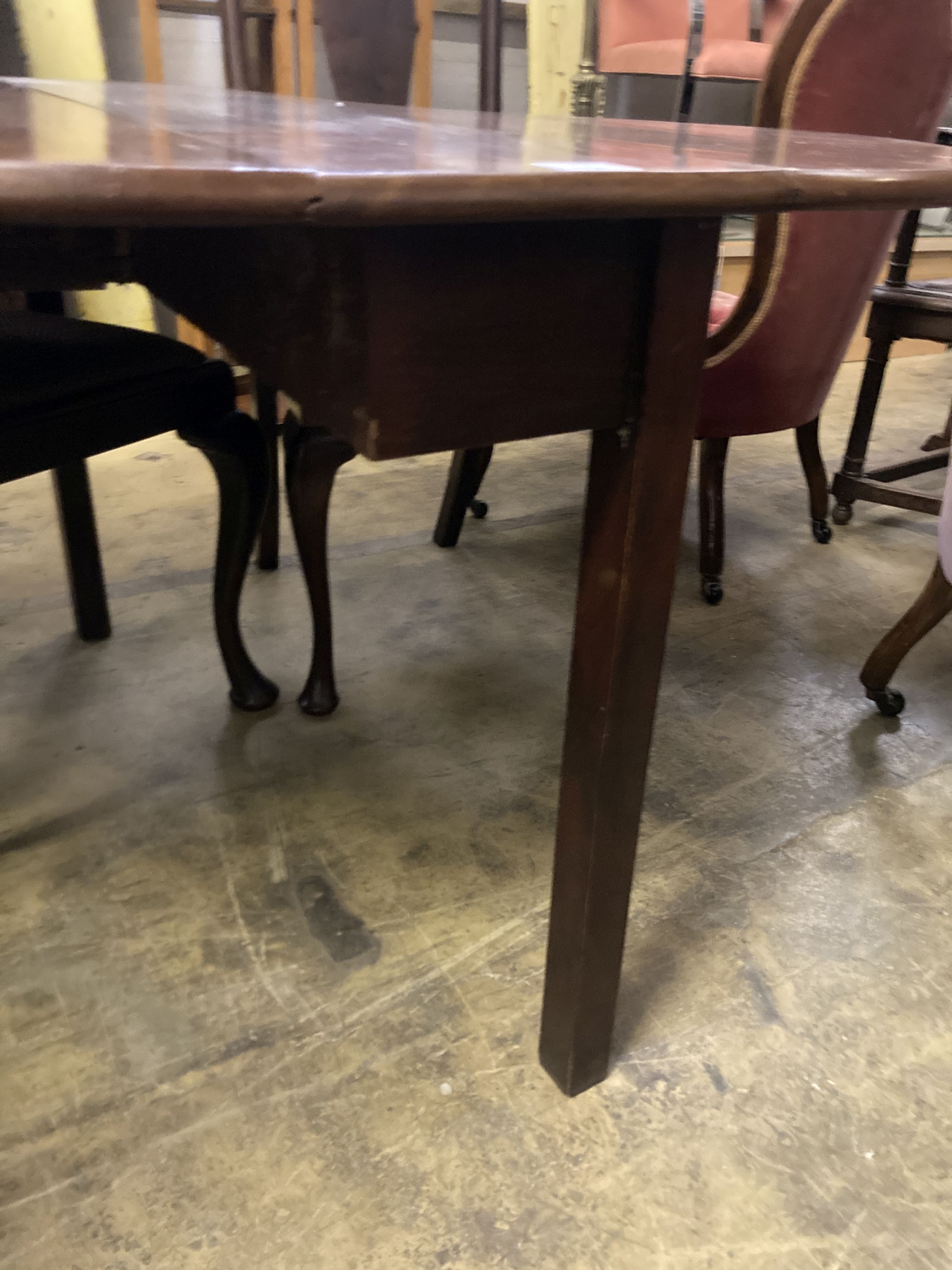 A George III mahogany cottage drop leaf dining table, width 106cm, length 128cm extended, height 70cm